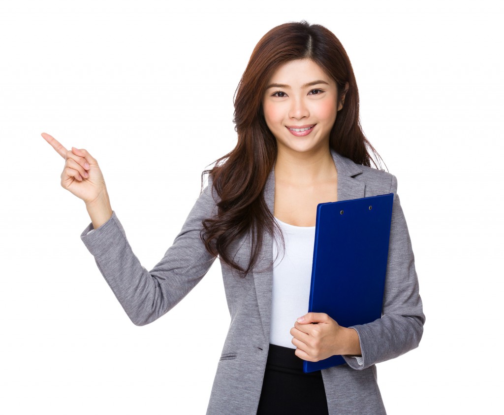 Asian businesswoman hold with clipboard and finger point up