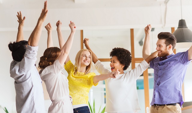 happy creative team celebrating victory in office